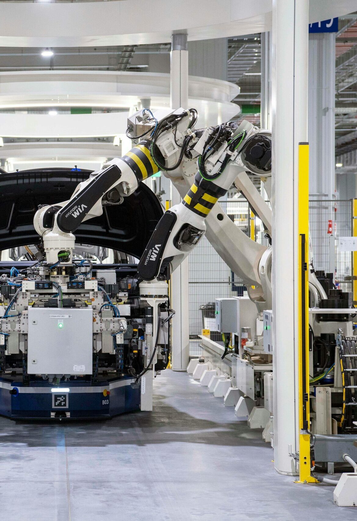 High-tech robots assembling a car in a modern factory setting, showcasing automation.